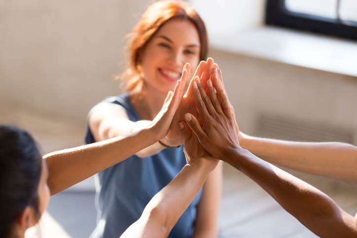 Girls giving high five, close up focus on hands