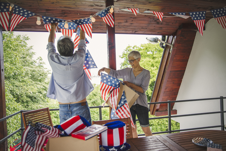 Senior couple decorating outdoor deck