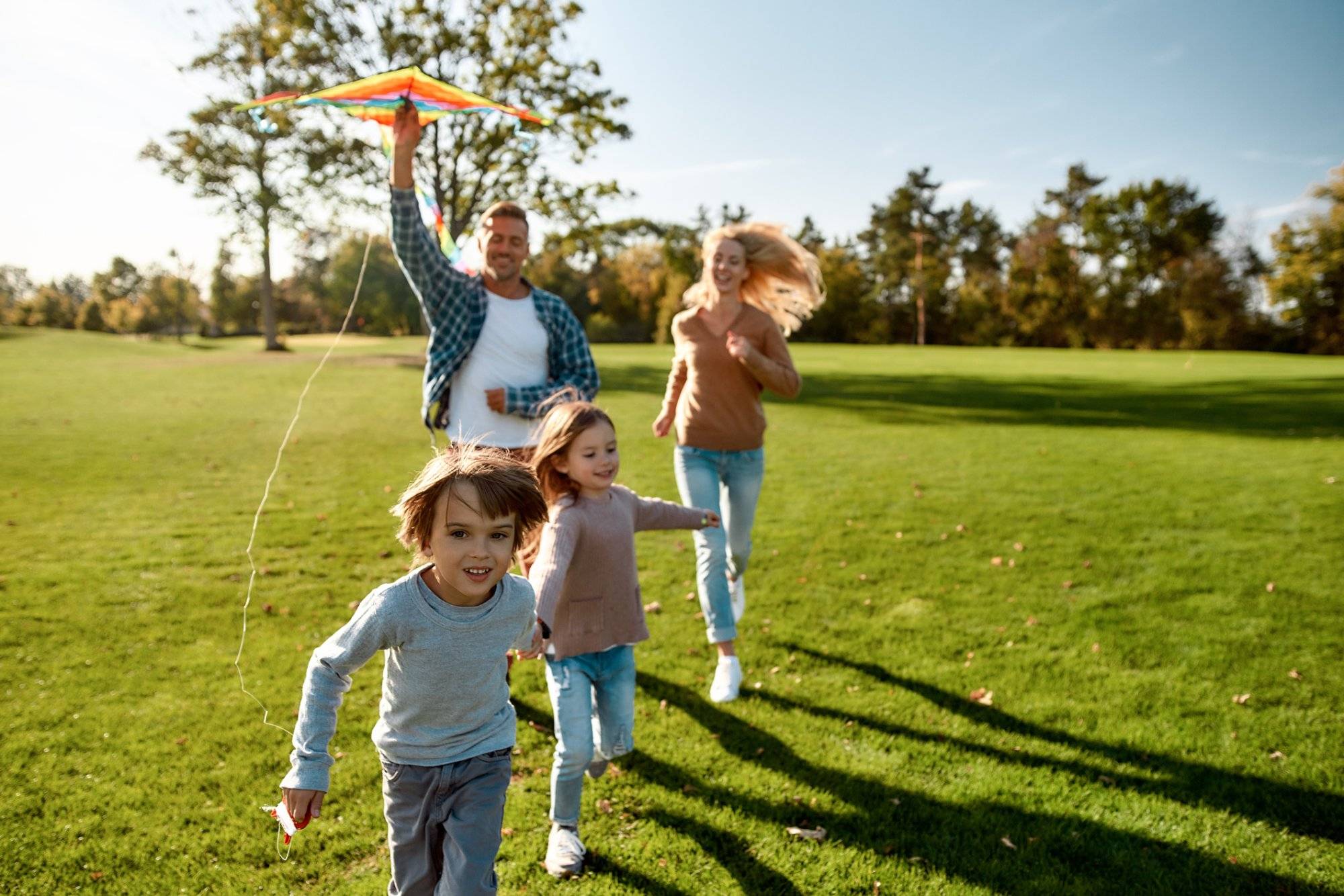 There are no words to describe how special kids are. Happy family playing a kite. Outdoor family weekend