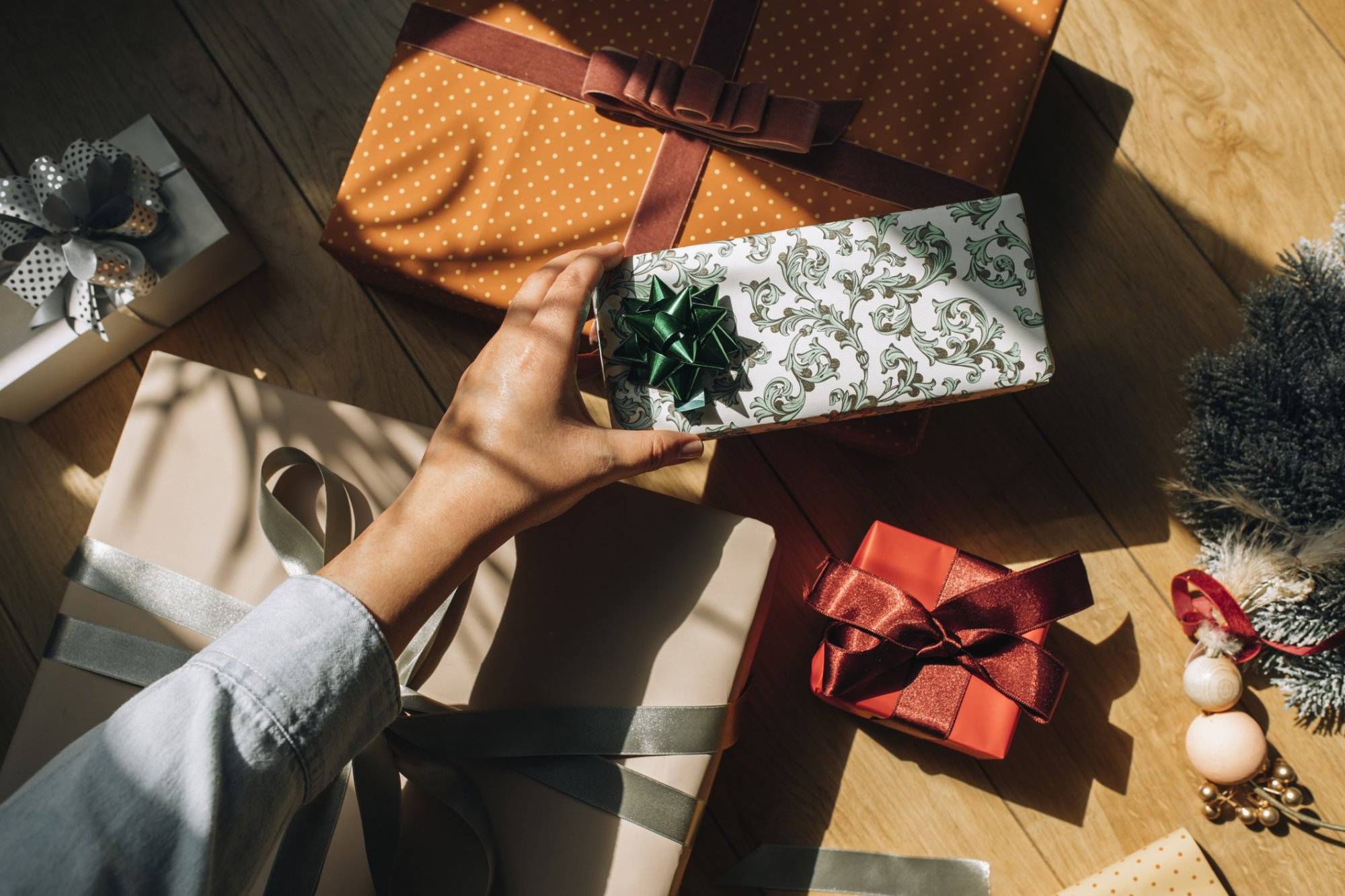 Hand of a Woman Holding a Wrapped Christmas Present, an Overhead View