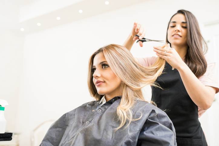 Hairdresser cutting some hair tips